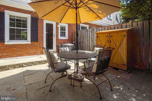 a view of a street with wooden fence