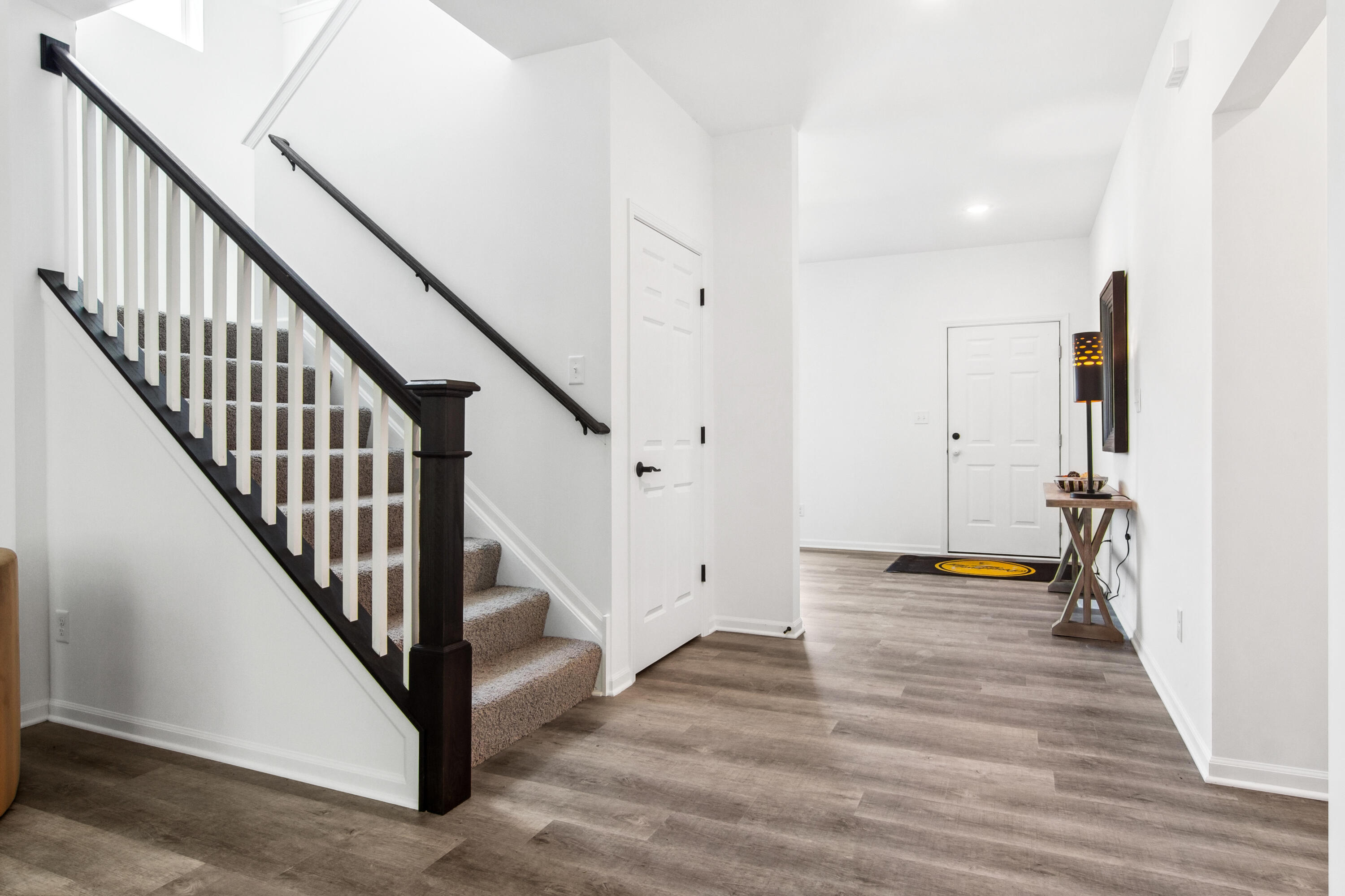 10360 California Street Crown Point, IN 46307 - Photo 6 of 22 a view of an entryway with wooden floor and stairs