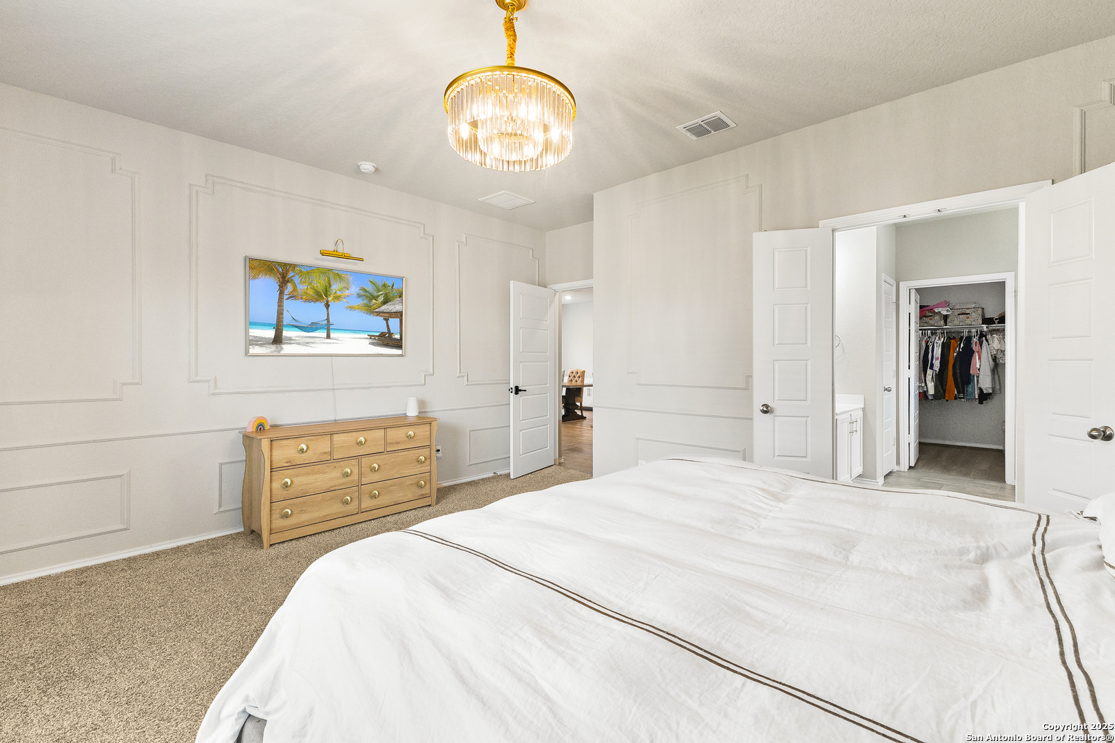 217 Stag Way Cibolo, TX 78108 - Photo 16 of 31 a bedroom with a bed and a chandelier