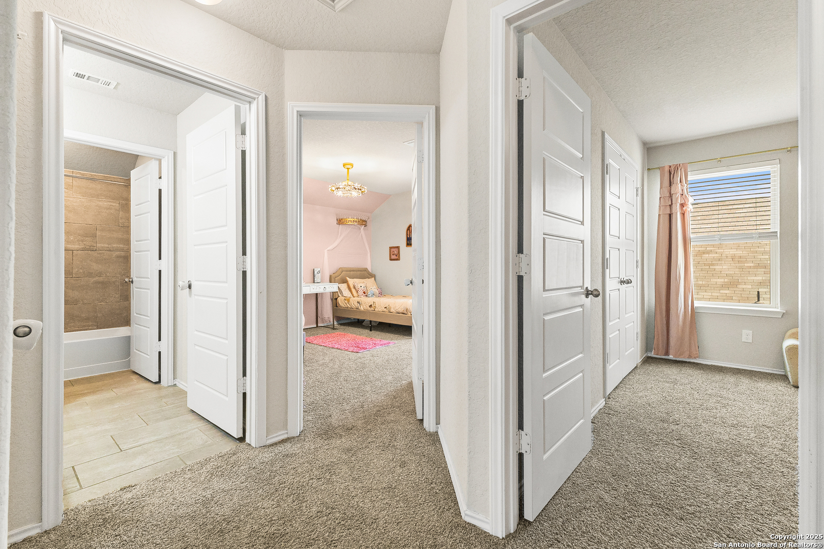 217 Stag Way Cibolo, TX 78108 - Photo 24 of 31 a view of a bedroom with a bed and wooden floor