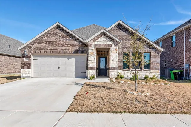 a view of the house with backyard and sitting area