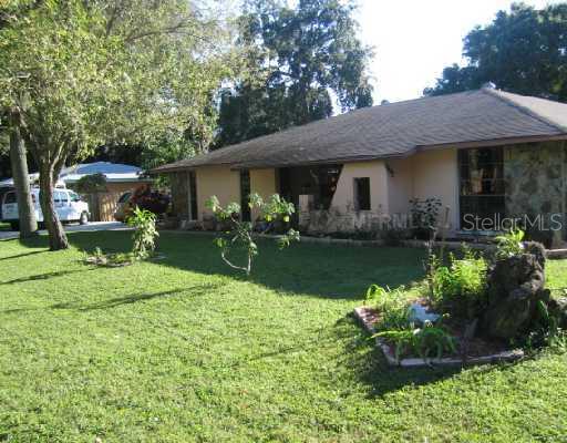 Exterior Front - Looking for room to stretch out?  This lovely home is in the middle of a triple lot....Plus complete privacy....So bring your family and all your toys.....There s plenty of space