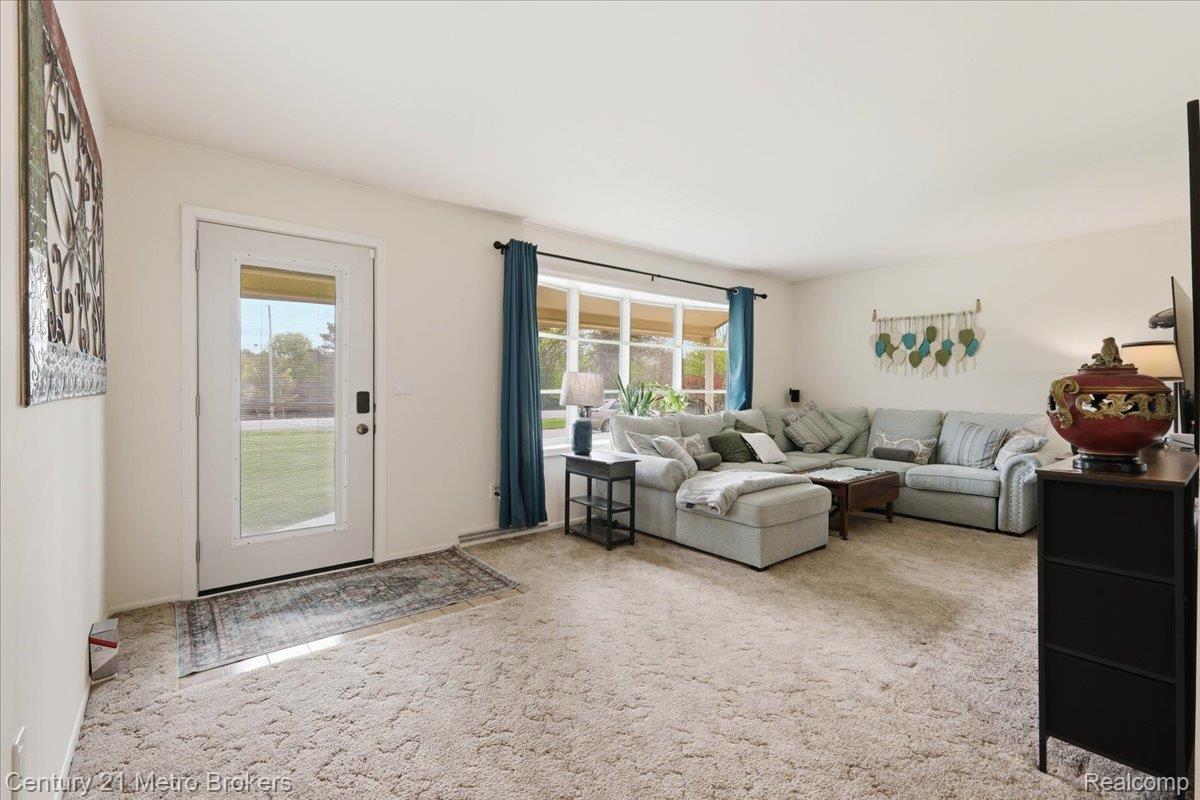 5457 North Seymour Road Flushing, MI 48433 - Photo 8 of 43 Living area with light colored carpet