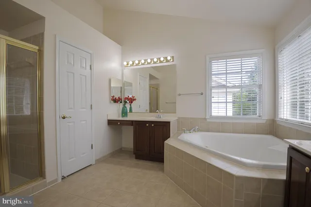 a spacious bathroom with sink shower and bathtub