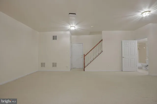 a view of an empty room with stairs