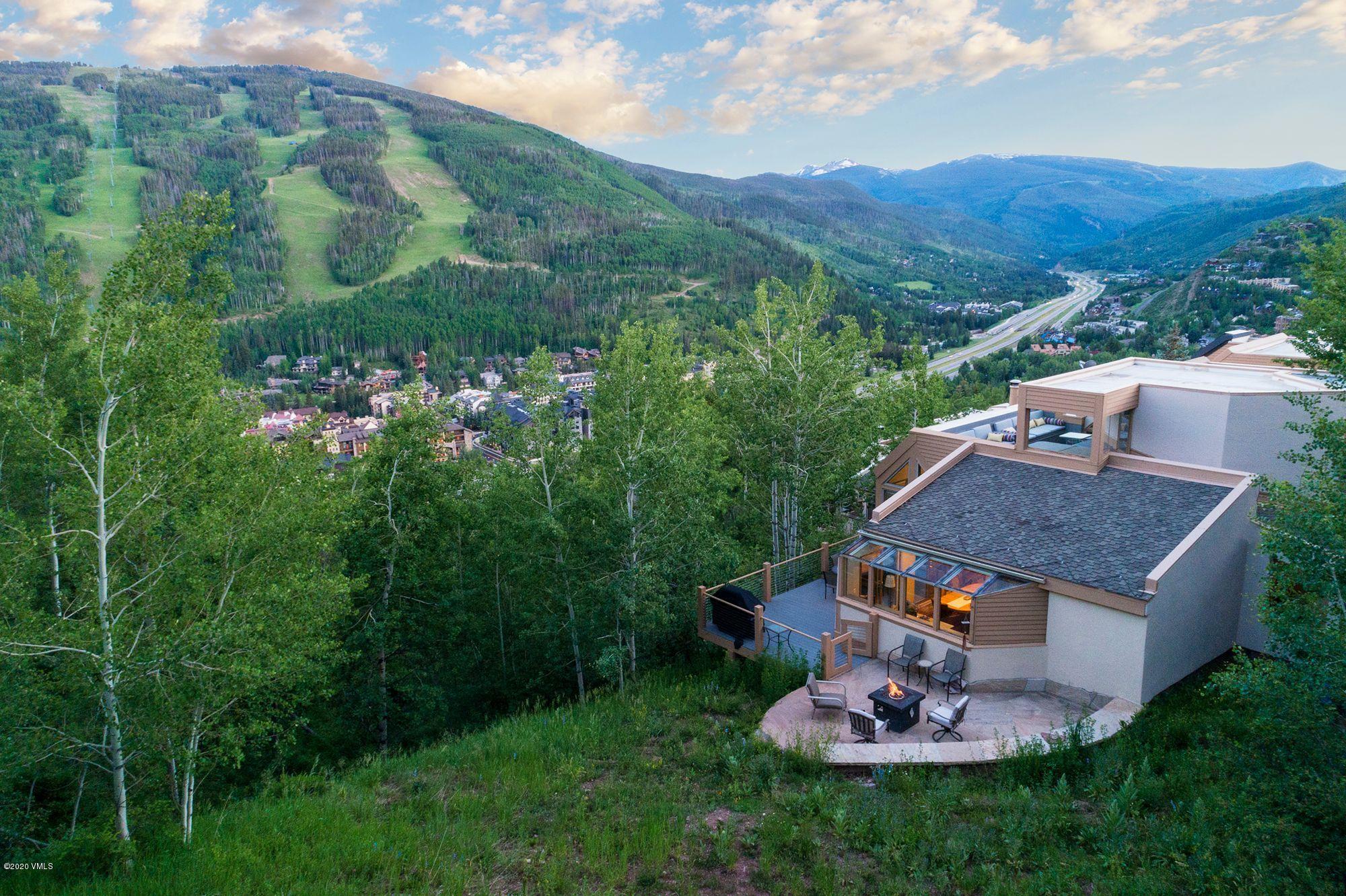 a view of a garden with a table and chairs