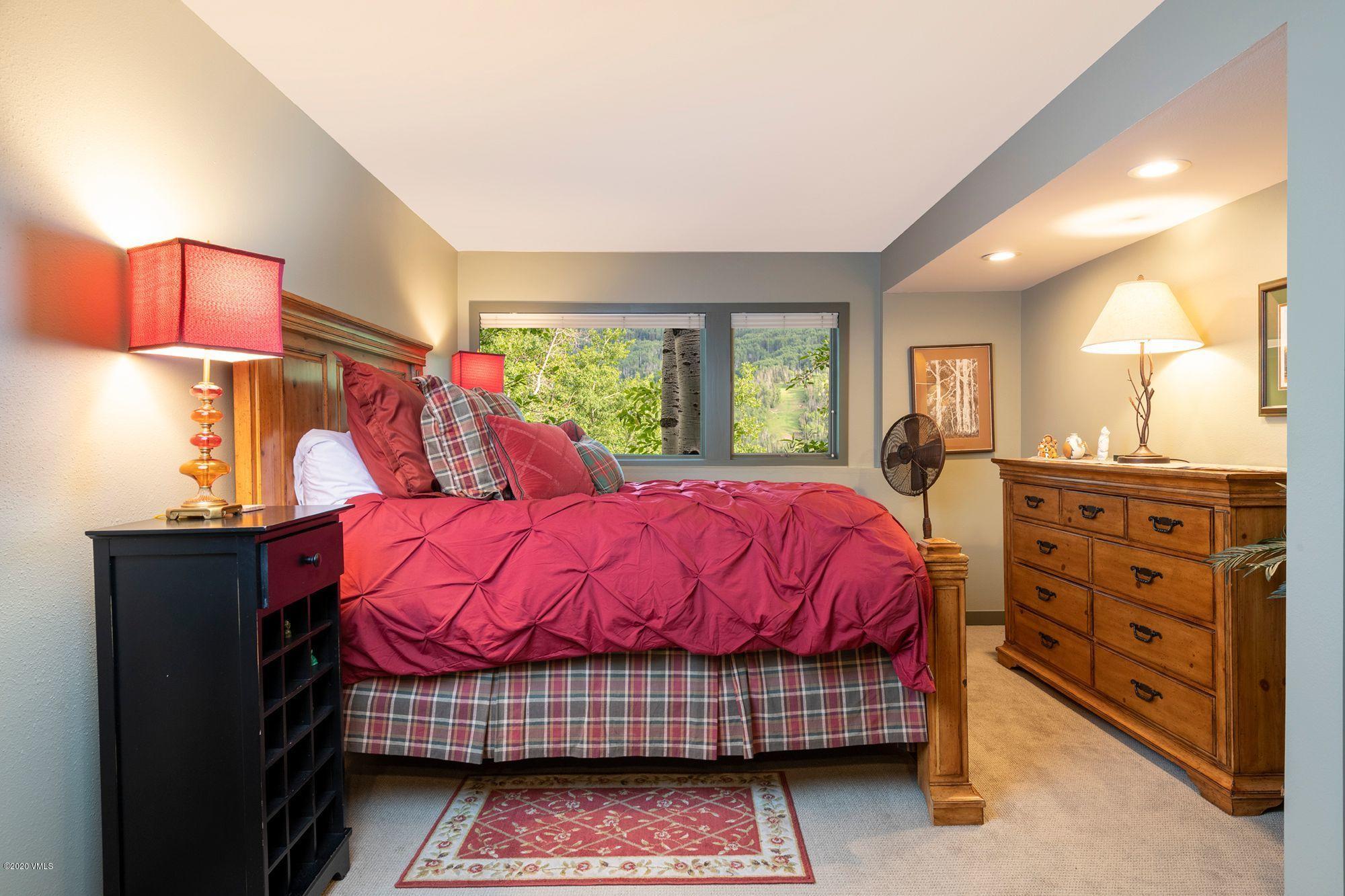 770 Potato Patch Drive, Unit 15 Vail, CO 81657 - Photo 14 of 23 a bed room with a bed and a dresser