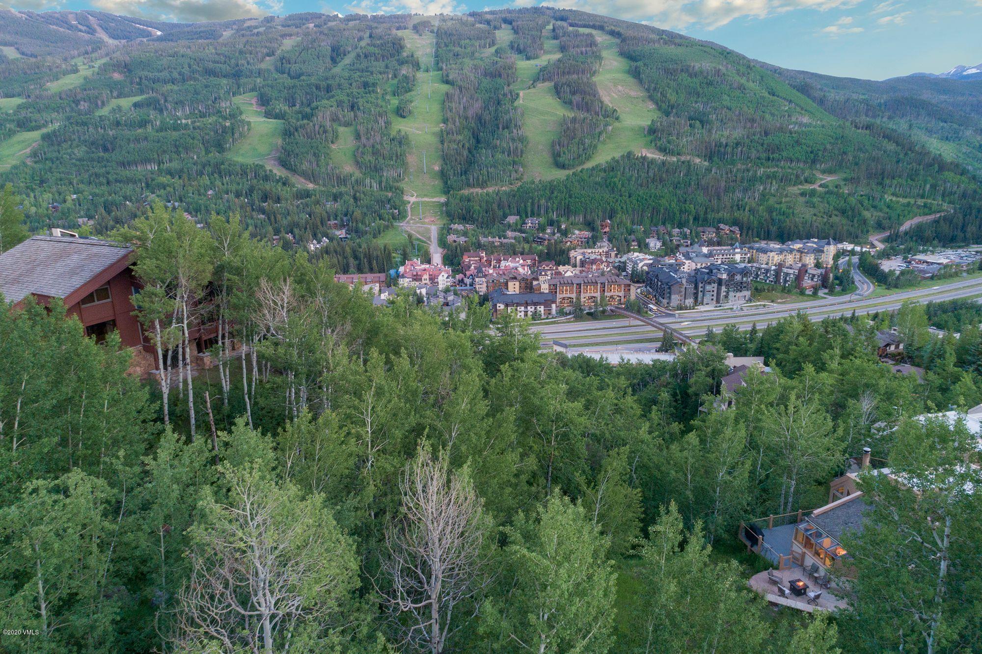 770 Potato Patch Drive, Unit 15 Vail, CO 81657 - Photo 2 of 23 a view of a city with lush green forest