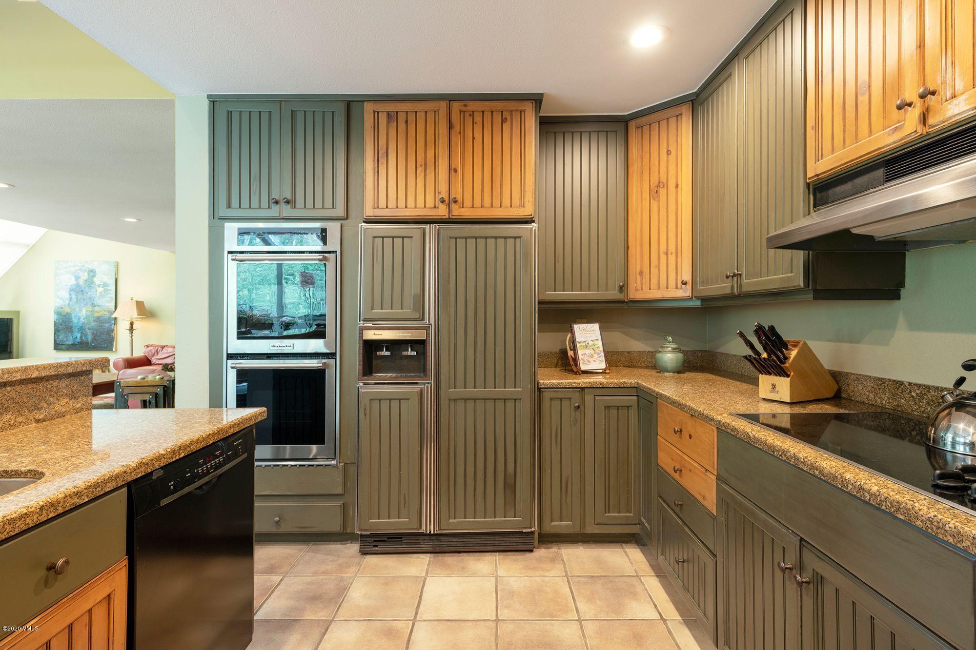 770 Potato Patch Drive, Unit 15 Vail, CO 81657 - Photo 6 of 23 a kitchen with stainless steel appliances granite countertop a refrigerator and sink
