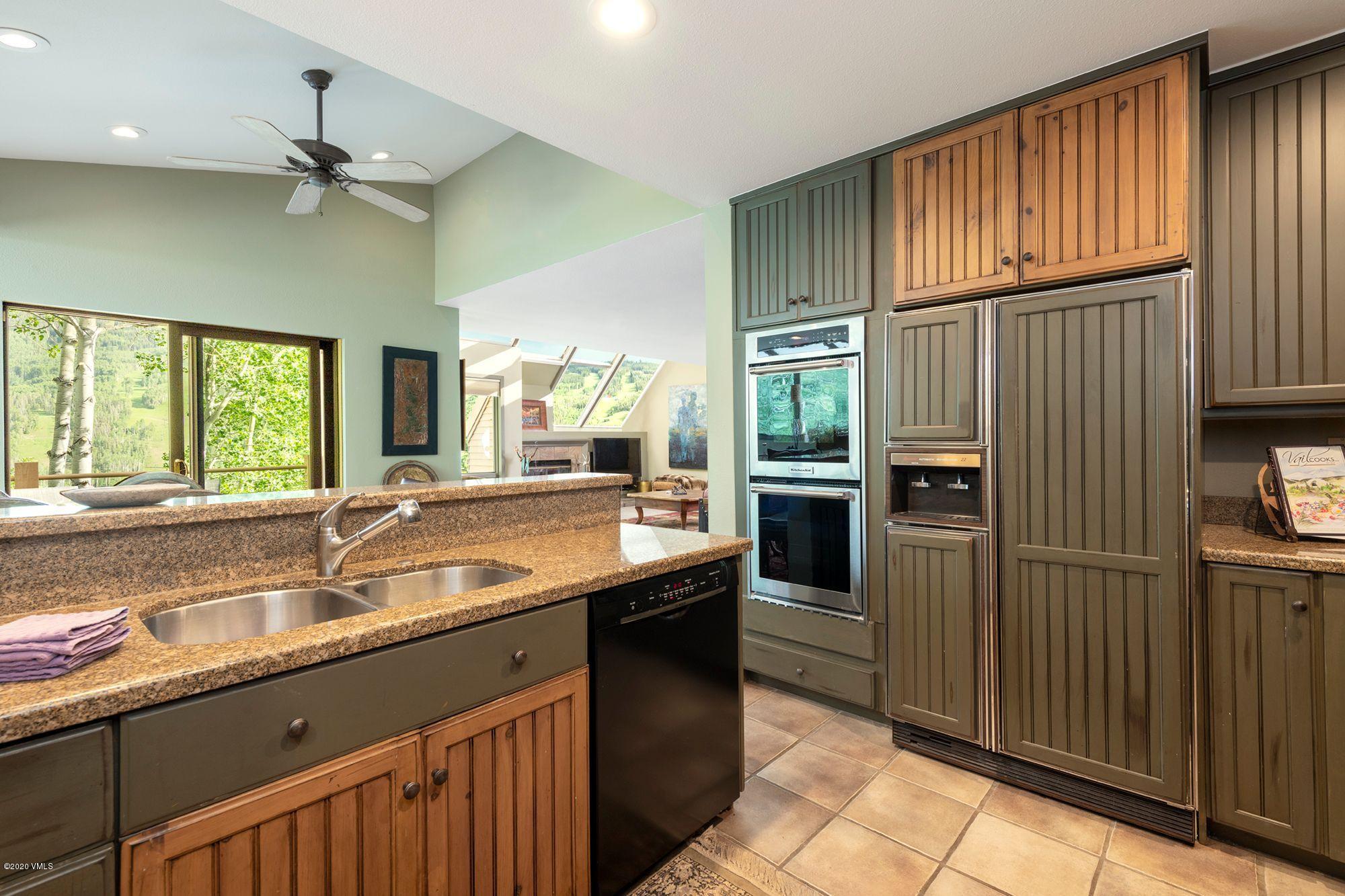 770 Potato Patch Drive, Unit 15 Vail, CO 81657 - Photo 7 of 23 a kitchen with stainless steel appliances granite countertop a sink and a refrigerator
