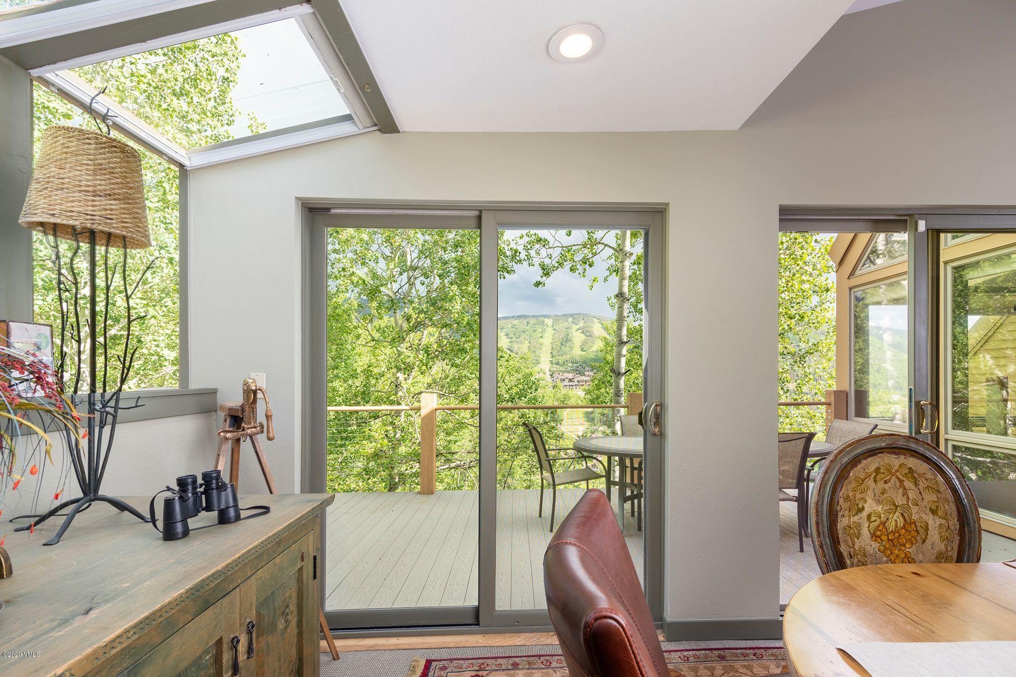 770 Potato Patch Drive, Unit 15 Vail, CO 81657 - Photo 10 of 23 a bathroom with a sink a large mirror and a window