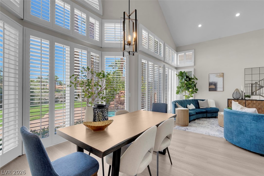 8848 Rainbow Ridge Drive Las Vegas, NV 89117 - Photo 5 of 43 A well-lit interior space with soaring vaulted ceilings and plantation shutters opening to exterior views.