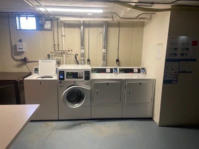 a utility room with sink dryer and washer