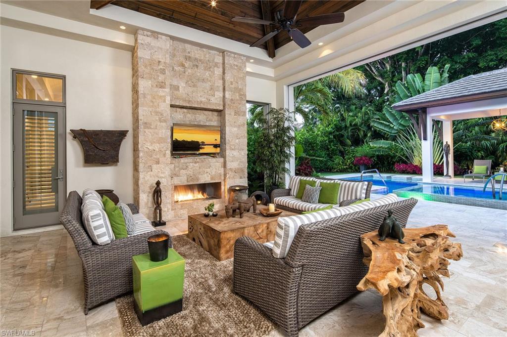 453 Spinnaker Drive Naples, FL 34102 - Photo 11 of 14 a view of a patio with couches chairs and a potted plant