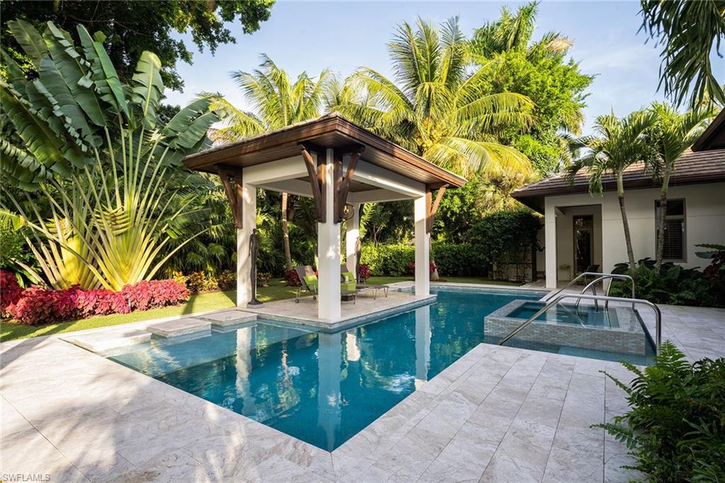 453 Spinnaker Drive Naples, FL 34102 - Photo 12 of 14 a view of a house with a patio