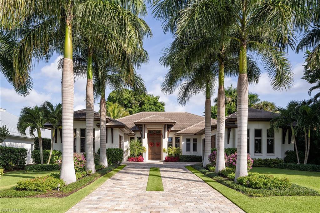 453 Spinnaker Drive Naples, FL 34102 - Photo 14 of 14 a front view of a house with garden and trees