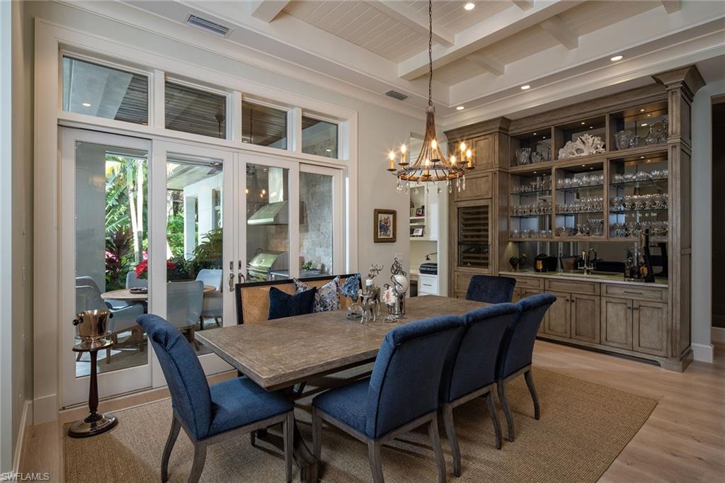 453 Spinnaker Drive Naples, FL 34102 - Photo 2 of 14 a view of a dining room with furniture and chandelier