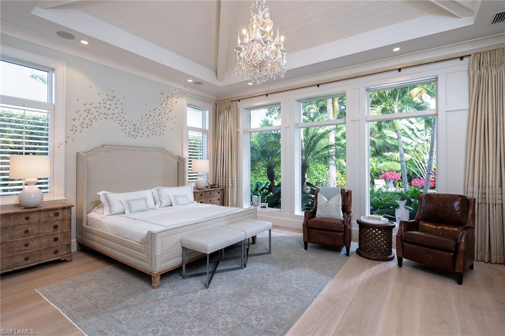 453 Spinnaker Drive Naples, FL 34102 - Photo 5 of 14 a bedroom with a bed and large windows