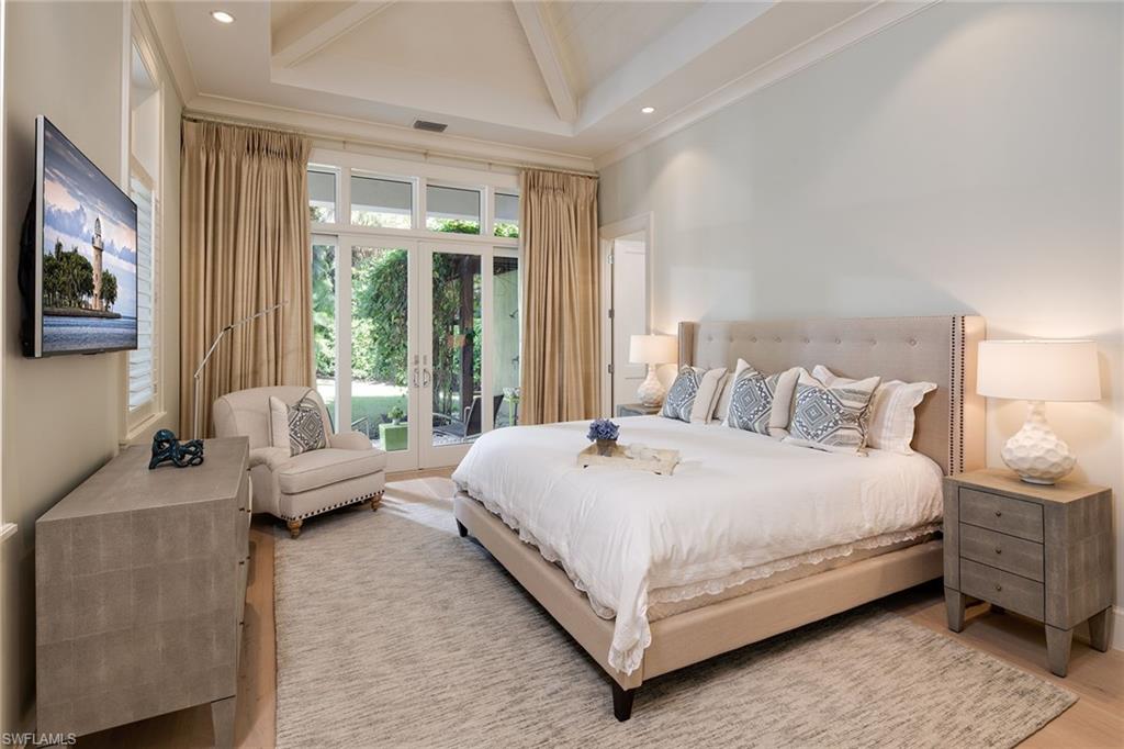 453 Spinnaker Drive Naples, FL 34102 - Photo 8 of 14 a bed room with a bed and a couch