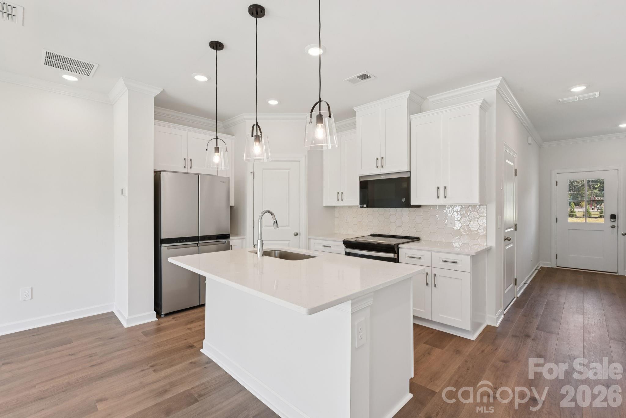433 Markridge Loop Fort Mill, SC 29708 - Photo 2 of 10 a kitchen with stainless steel appliances kitchen island a sink stove and refrigerator
