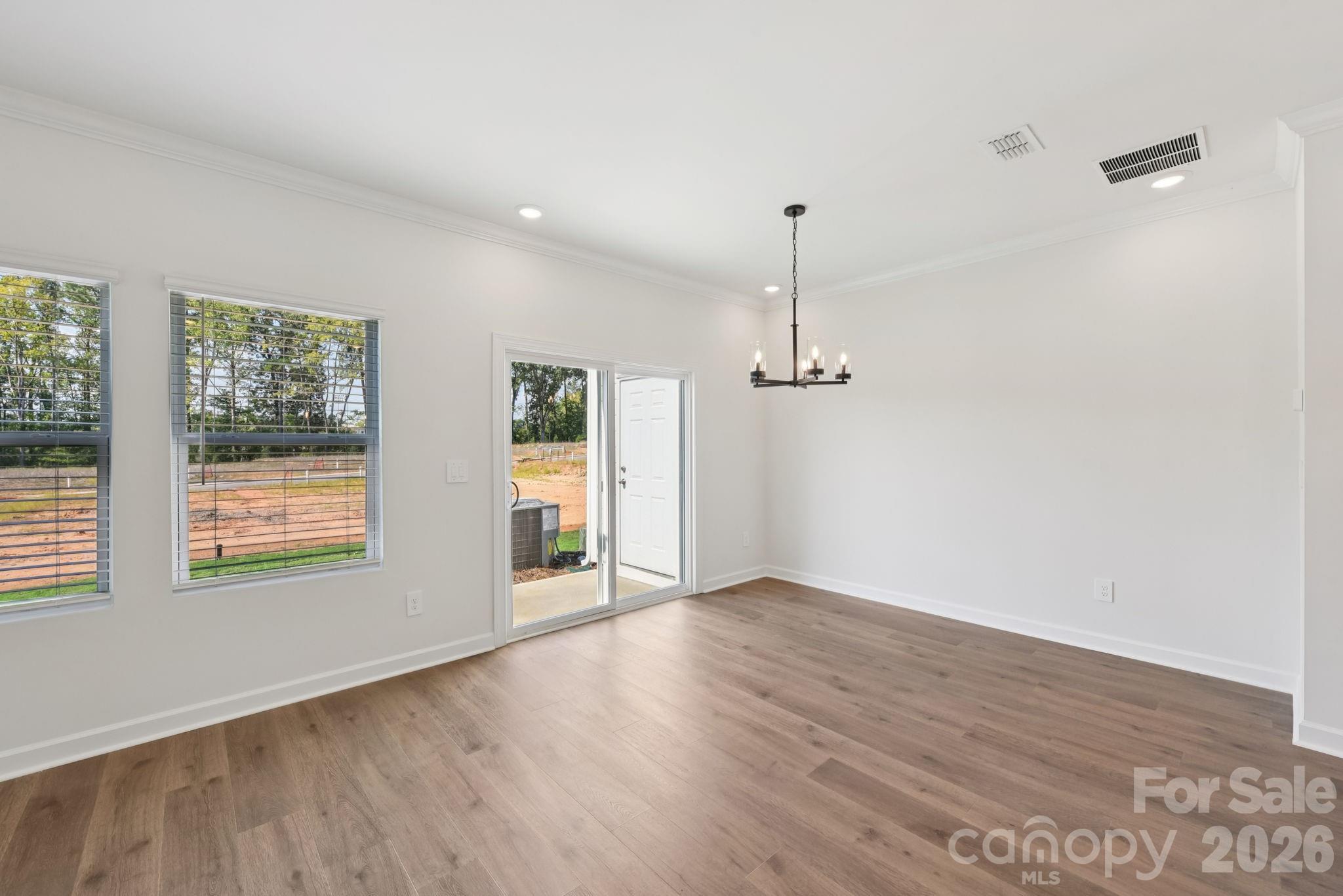 433 Markridge Loop Fort Mill, SC 29708 - Photo 4 of 10 an empty room with wooden floor and windows