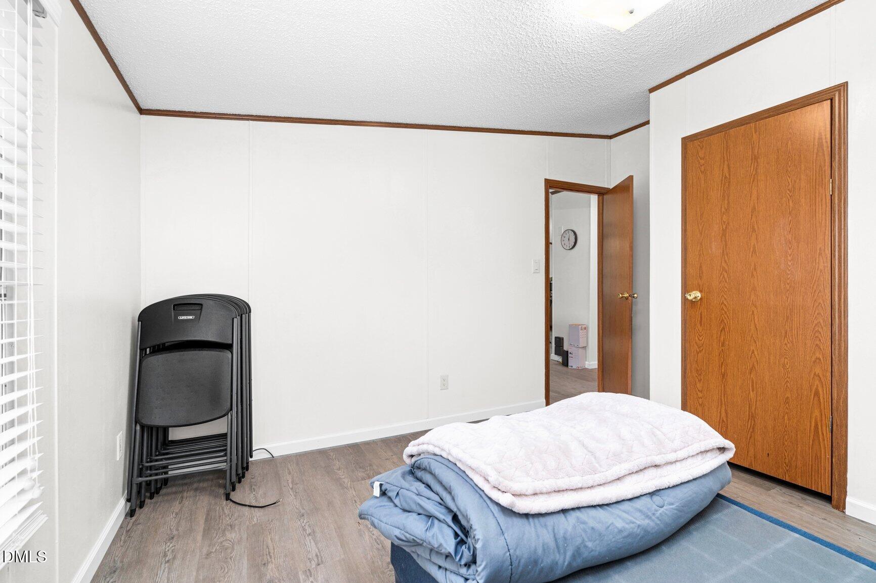 1835 Cokey Road Rocky Mount, NC 27801 - Photo 18 of 42 a bedroom with a bed and a mirror
