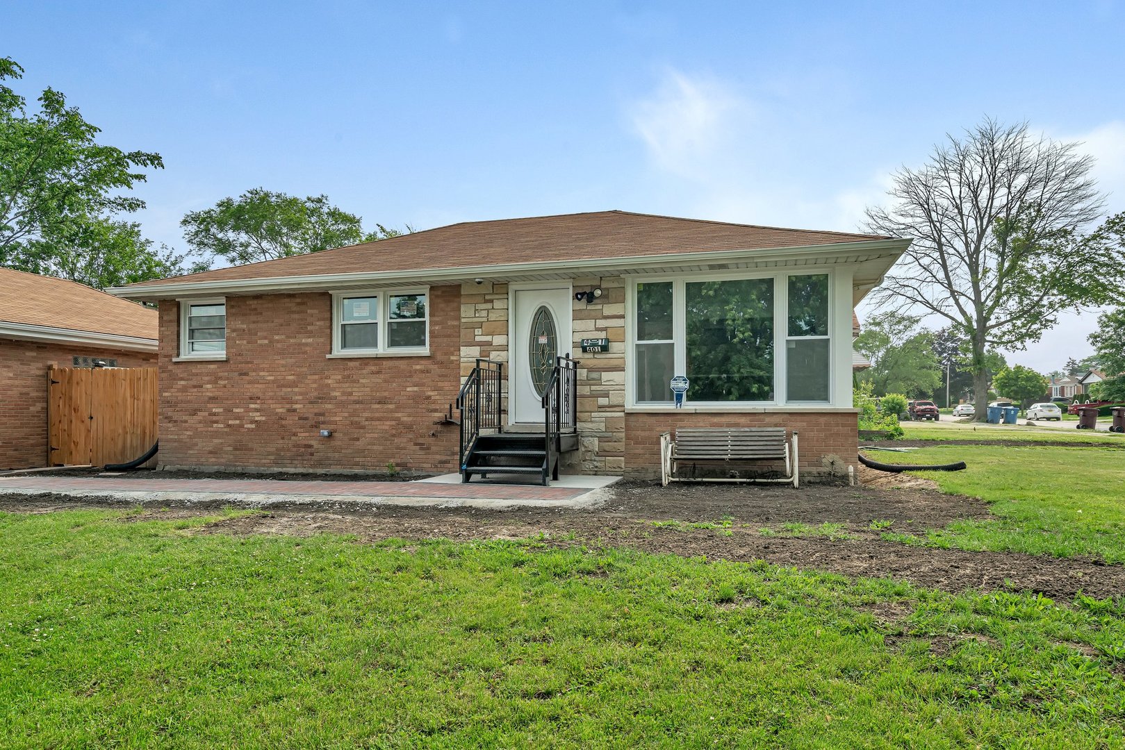 a view of a house with a yard and sitting area