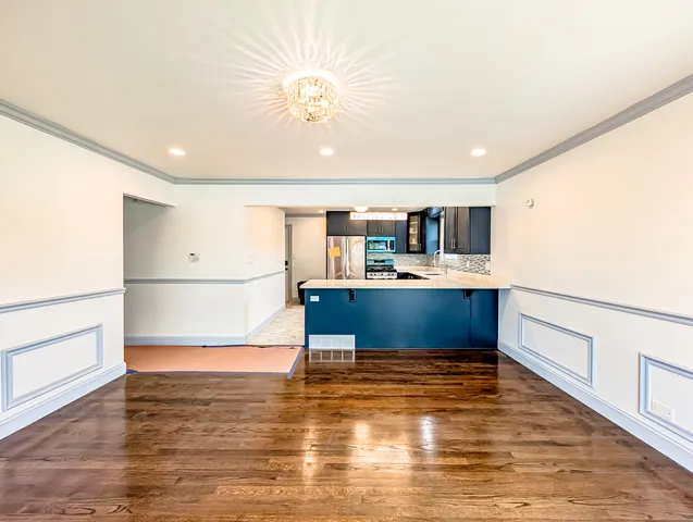 a view of kitchen with cabinets and wooden floor