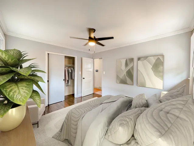 a bedroom with a bed and a chandelier