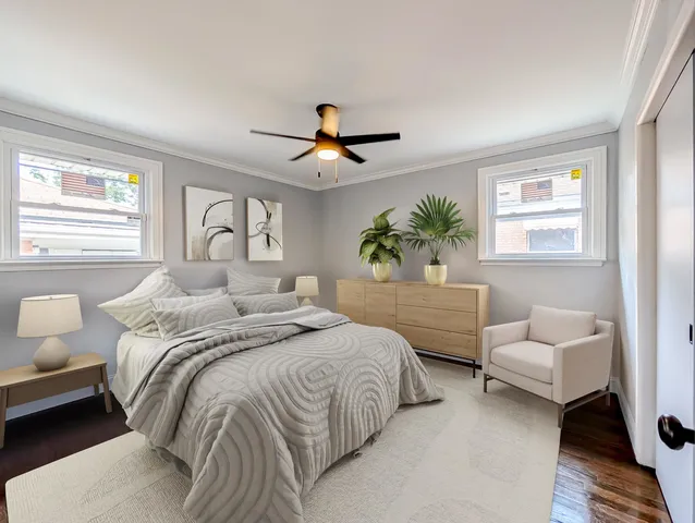 a bedroom with a bed couches chair and a large window