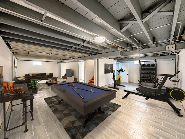 a outdoor space with pool table and chairs