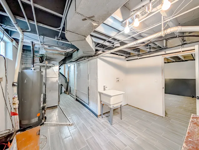 a view of walk in closet with wooden floors