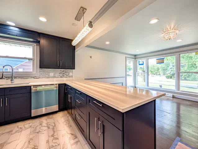 a kitchen with a sink stove and cabinets