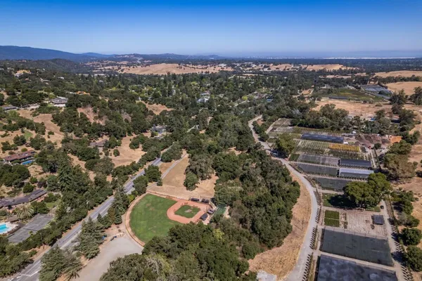 an aerial view of a houses with a yard
