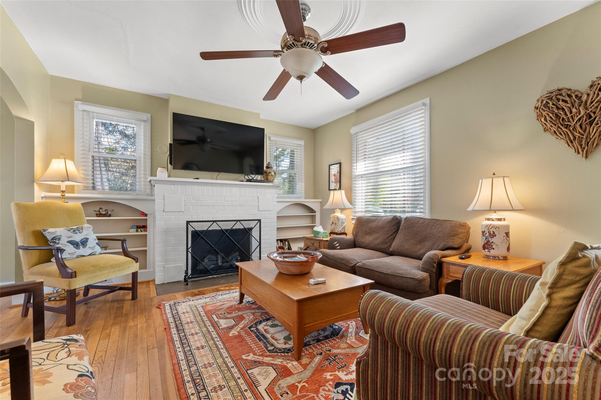 580 Maple Street Brevard, NC 28712 - Photo 12 of 28 a living room with furniture a flat screen tv and a fireplace