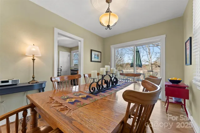 a view of a dining room with furniture a chandelier and wooden floor