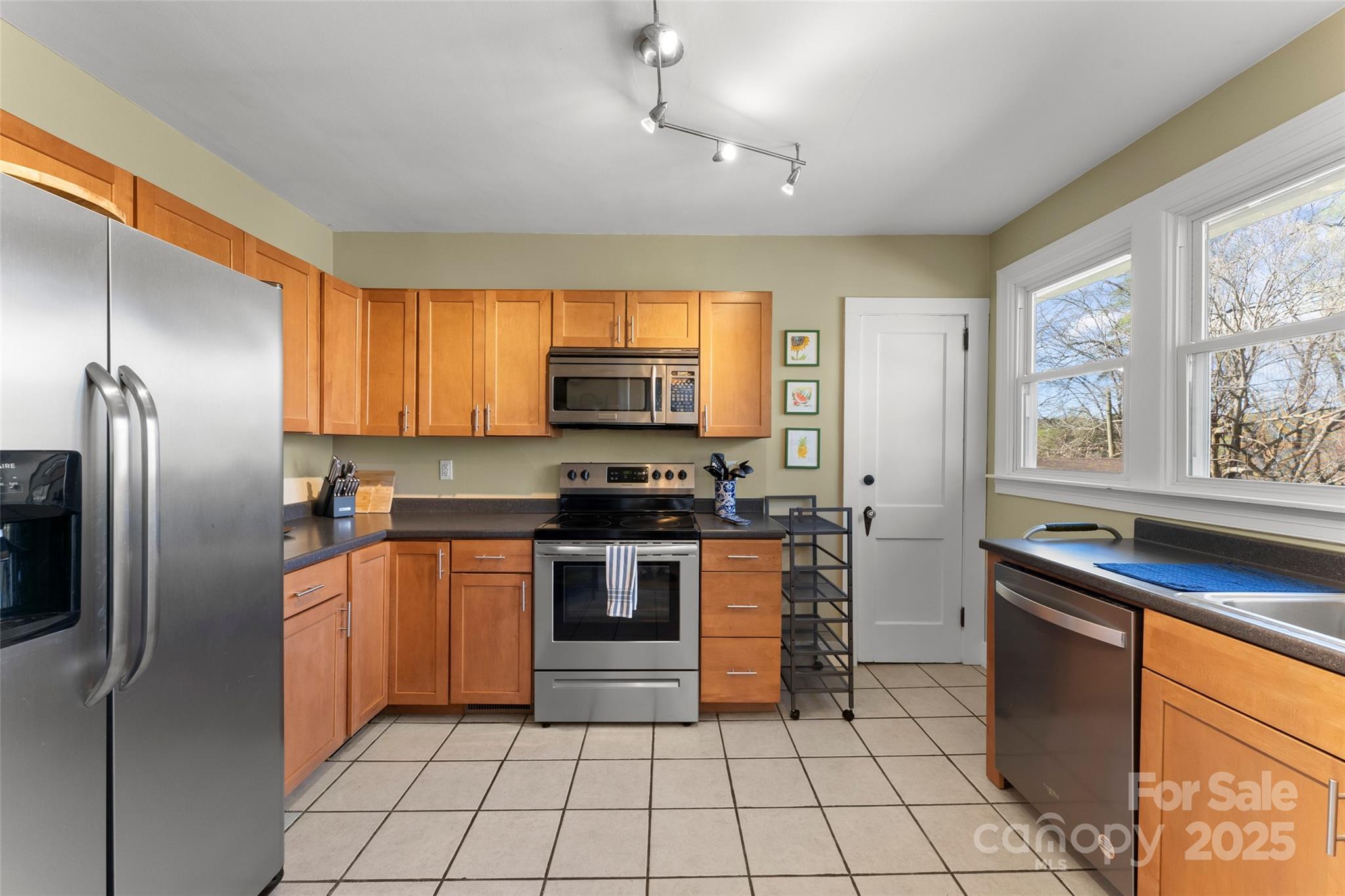 580 Maple Street Brevard, NC 28712 - Photo 16 of 28 a kitchen with stainless steel appliances granite countertop a refrigerator and a stove top oven
