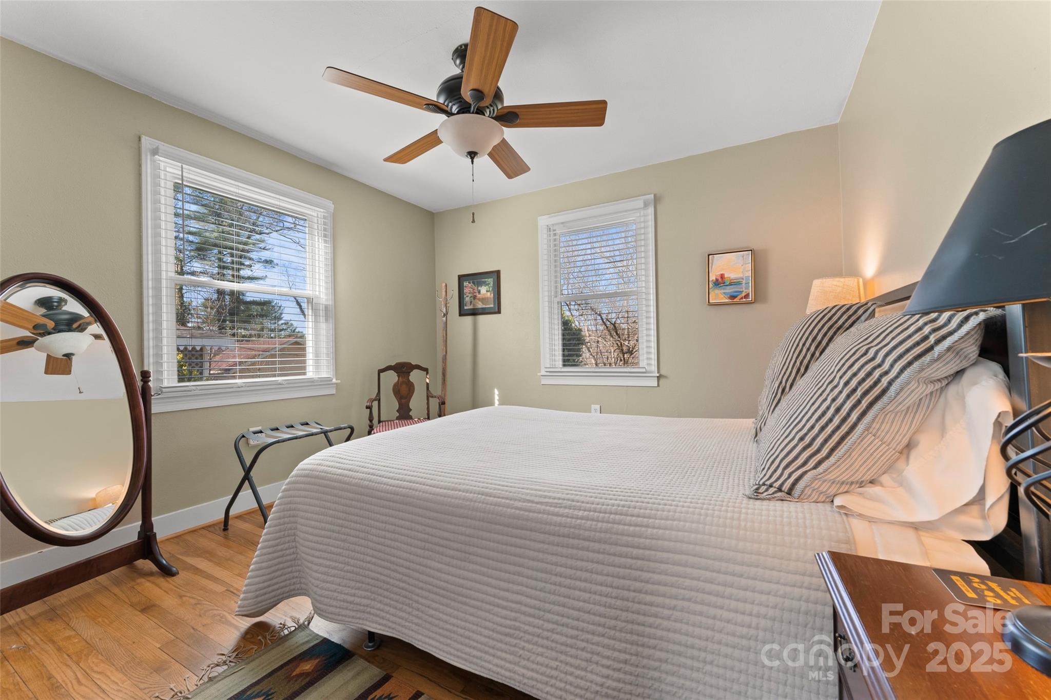 580 Maple Street Brevard, NC 28712 - Photo 19 of 28 a bedroom with a bed a chandelier and a window