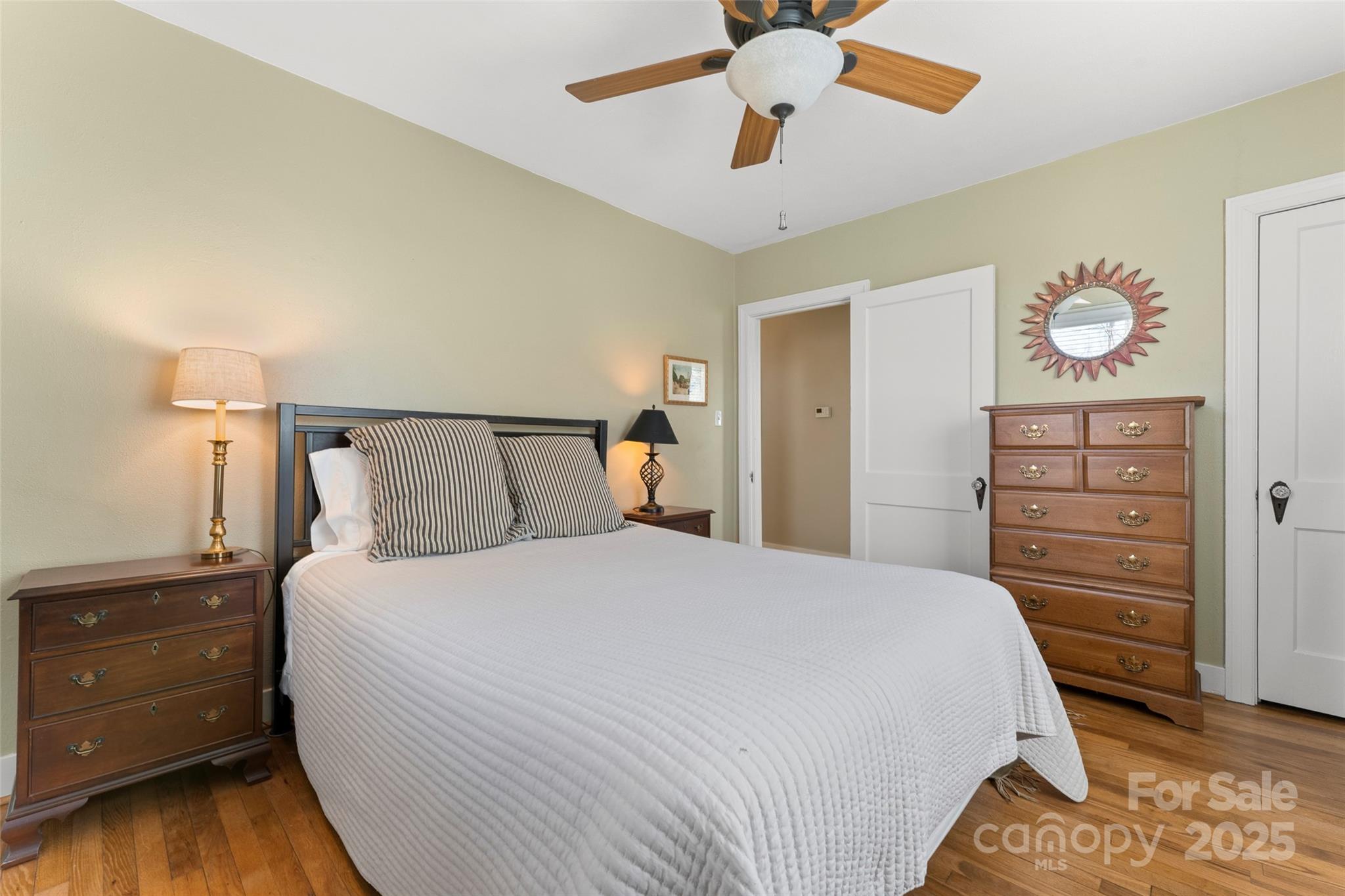 580 Maple Street Brevard, NC 28712 - Photo 20 of 28 a bedroom with a bed and a chandelier