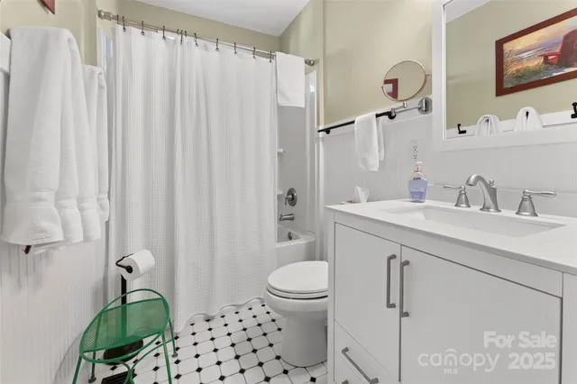 a bathroom with a sink a toilet and shower curtain