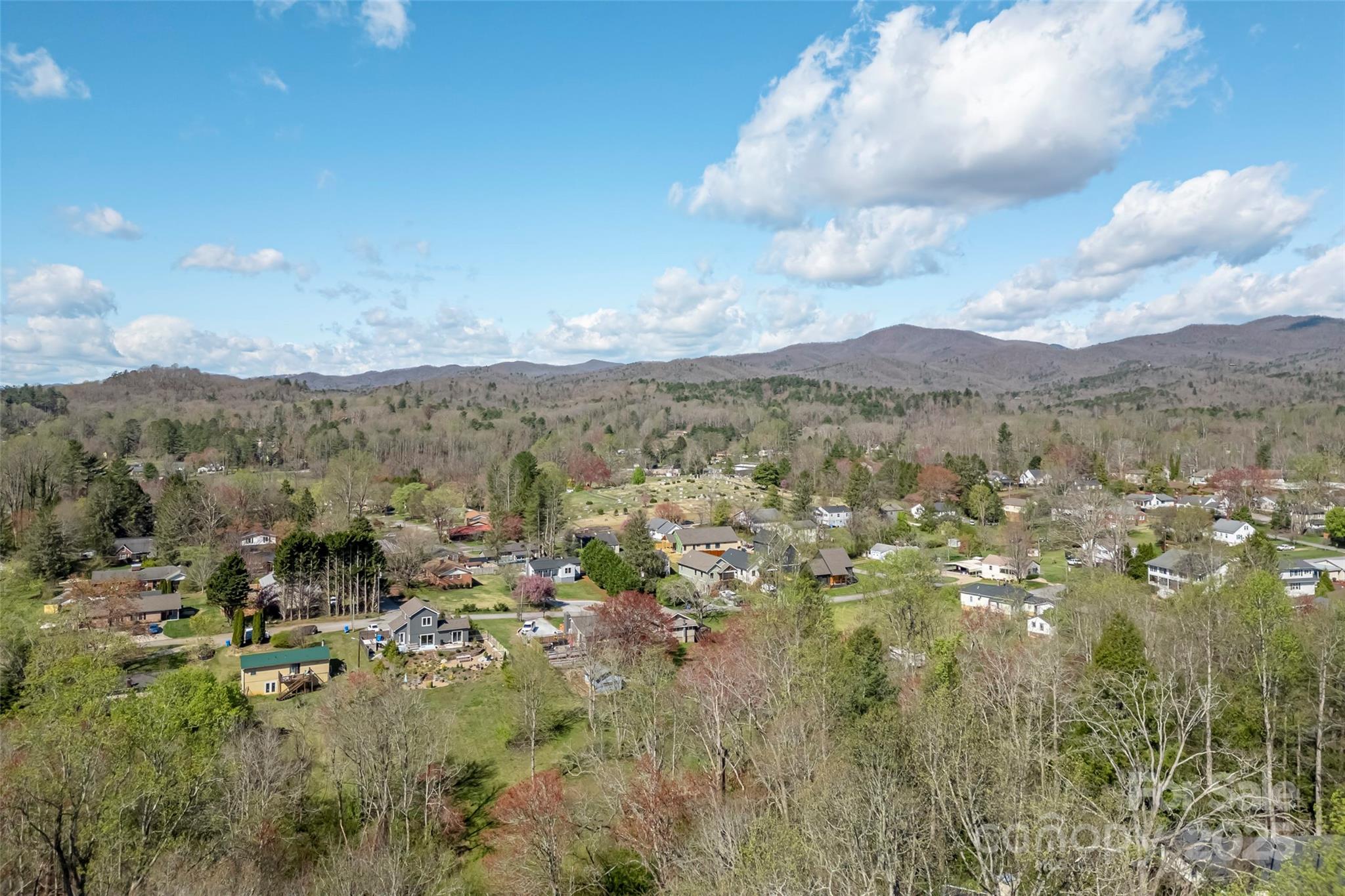 580 Maple Street Brevard, NC 28712 - Photo 28 of 28 a view of a city with lots of residential buildings and mountain view in back