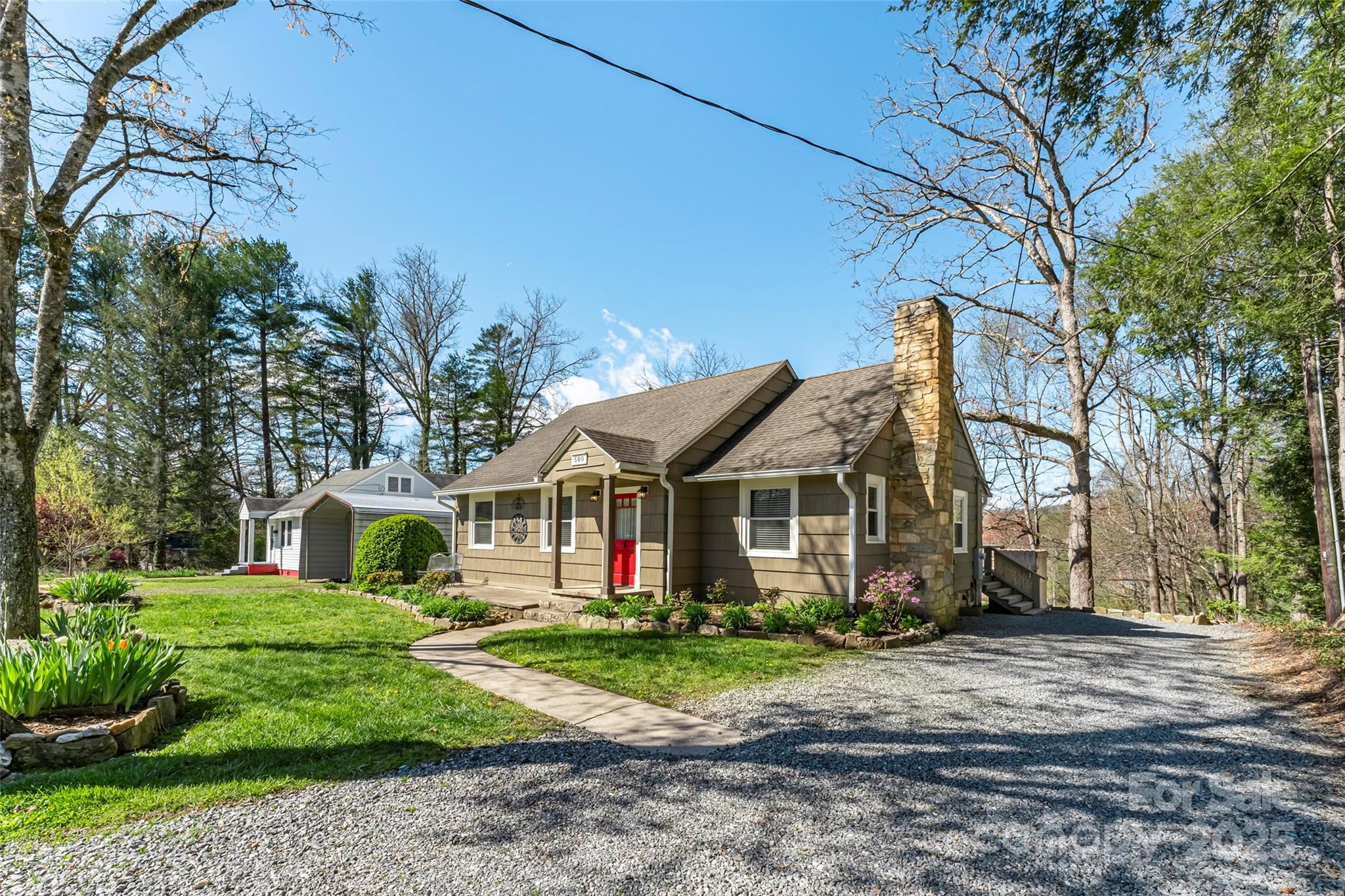 580 Maple Street Brevard, NC 28712 - Photo 7 of 28 a front view of a house with a yard and trees