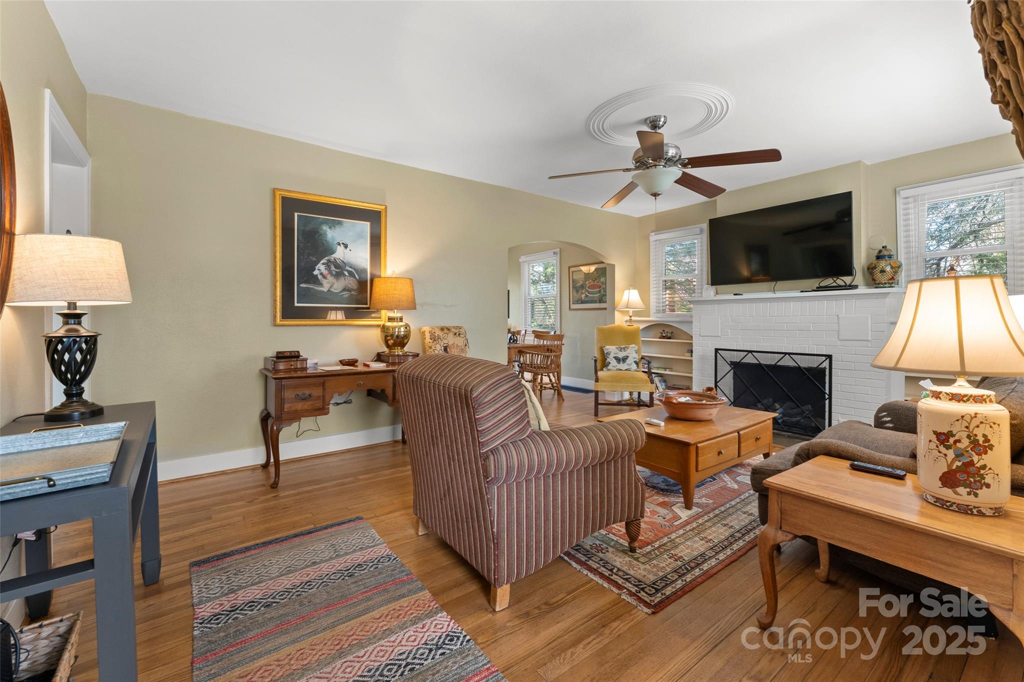 580 Maple Street Brevard, NC 28712 - Photo 10 of 28 a living room with furniture a flat screen tv and a fireplace