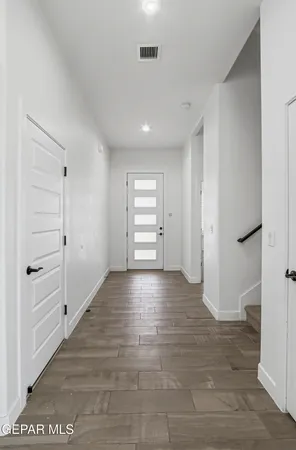 a kitchen with white cabinets and black appliances