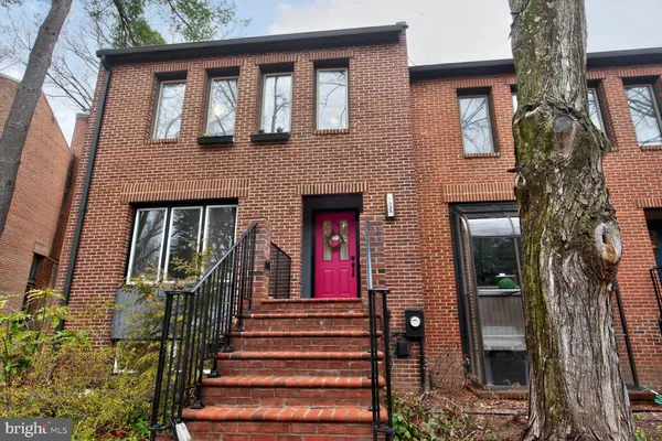 front view of a brick house with a large window