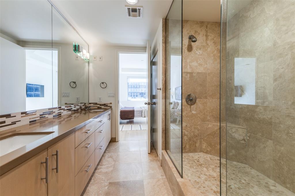 1505 Elm Street, Unit 1004 Dallas, TX 75201 - Photo 16 of 32 a spacious bathroom with a shower sink and mirror