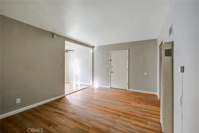 a view of an empty room with wooden floor