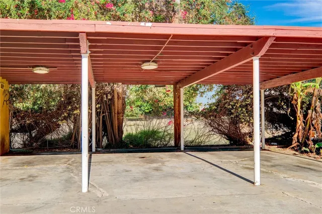 a view of a patio with a table and chairs under an umbrella