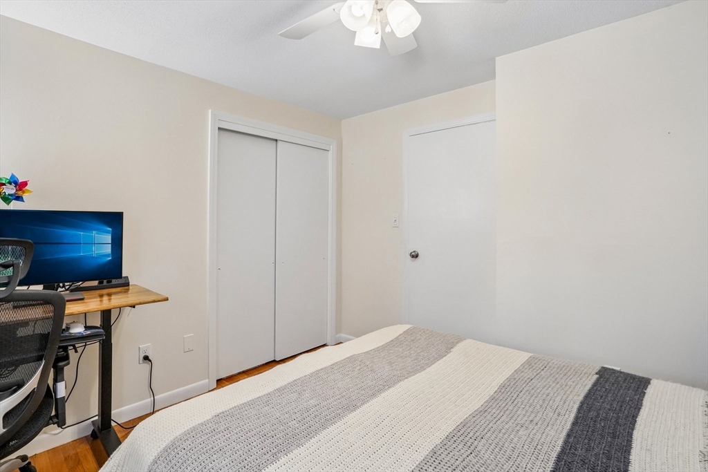 35 Westgate Road Framingham, MA 01701 - Photo 19 of 37 a bedroom with a bed and a chandelier