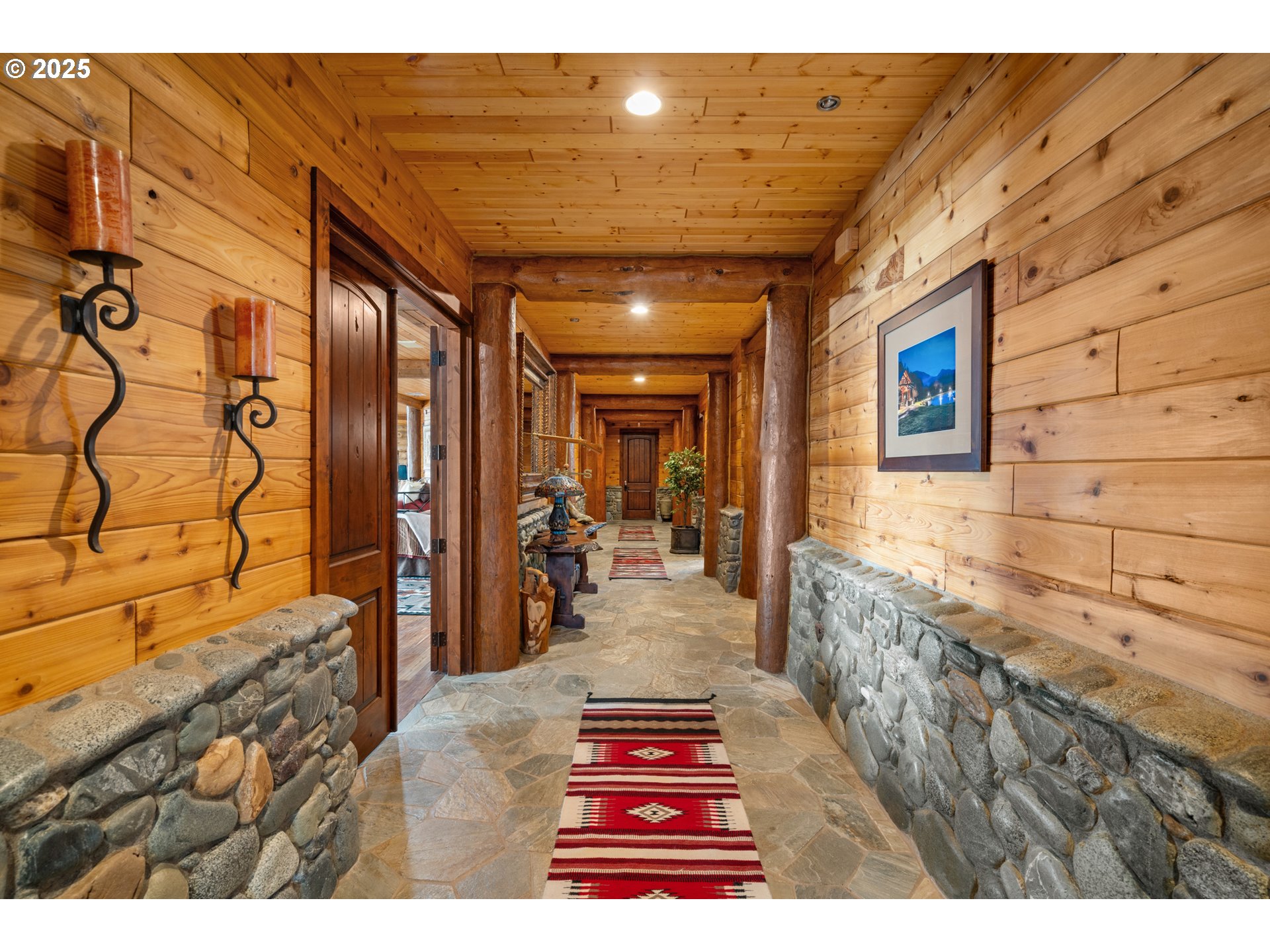 35400 Highway 101 Gold Beach, OR 97444 - Photo 13 of 46 a hallway with a large stone wall